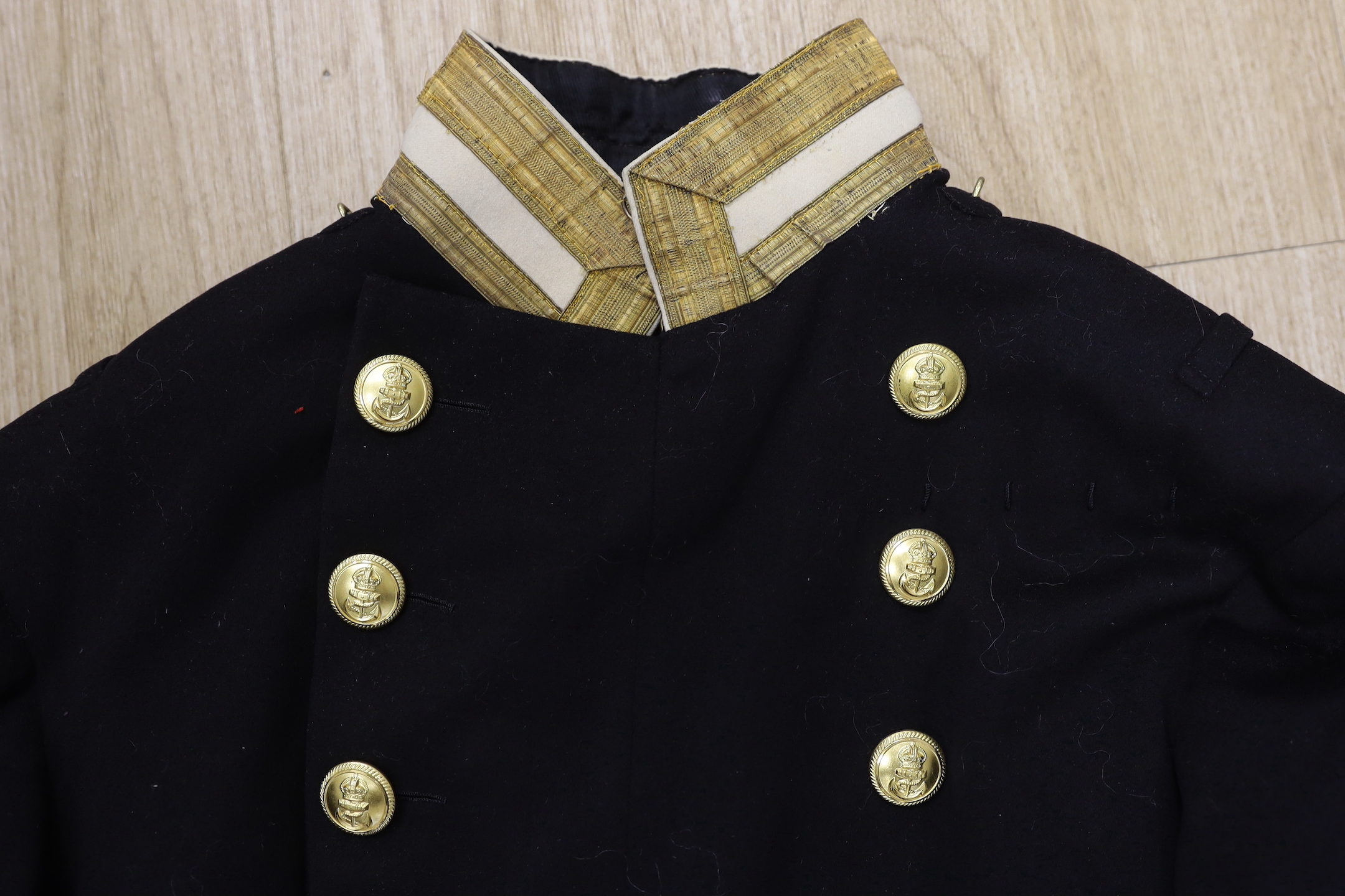 A 19th century gentleman's black wool Naval tail jacket with brass buttons gold